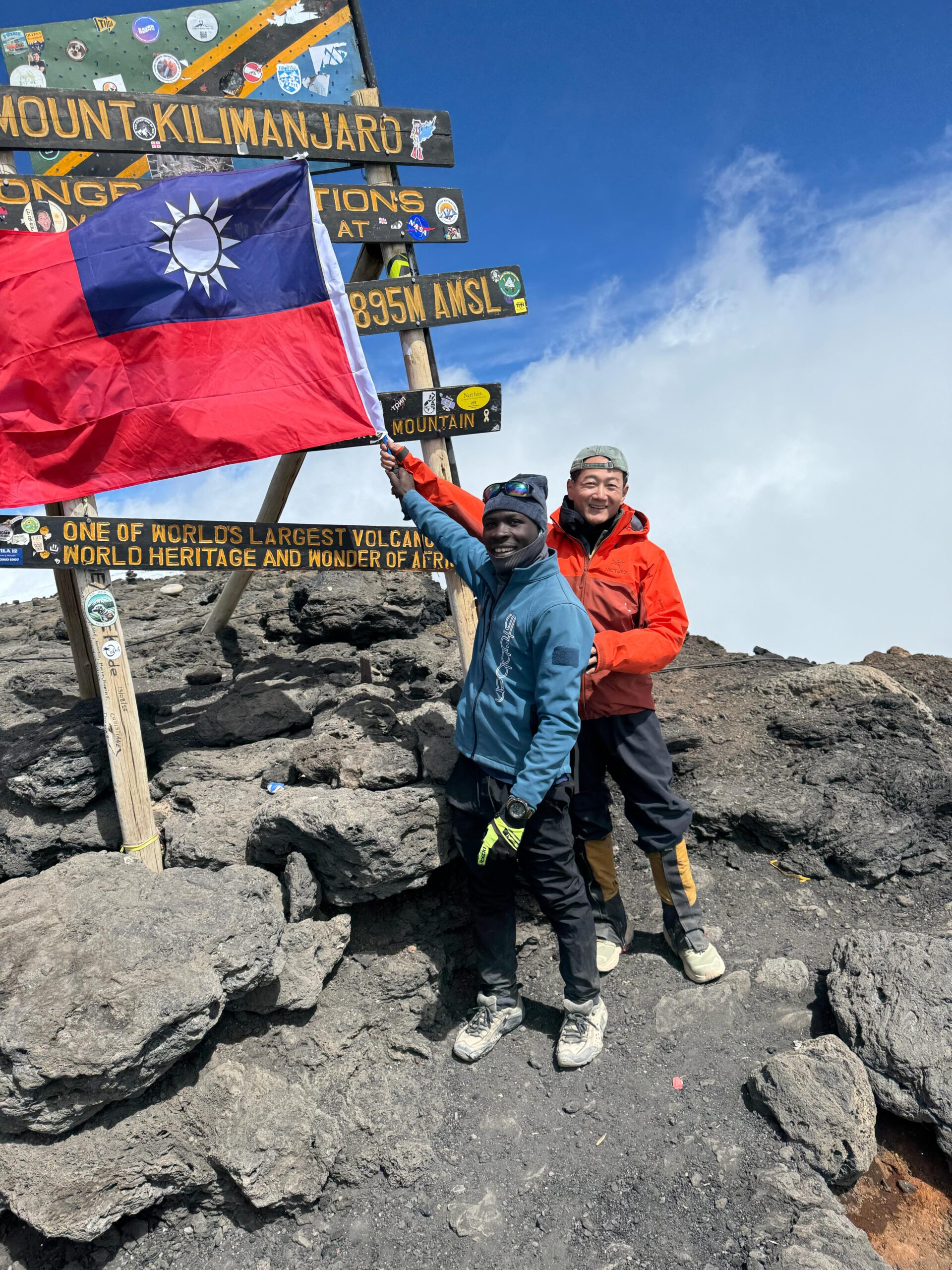 Client from Taiwan with flag at summit