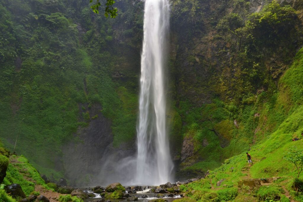 Day Trips from Moshi Explore the breathtaking beauty of a towering waterfall in the verdant tropical rainforest of West Java, Indonesia.