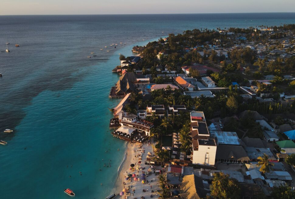 Stunning aerial photograph of Nungwi Beach, Zanzibar capturing the serene coastline at sunset.